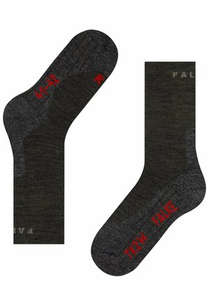 Calcetines verde oscuro con acentos grises, que cuentan con áreas acolchadas, punta y talón reforzados, y texto rojo que muestra información sobre el tamaño y la marca.