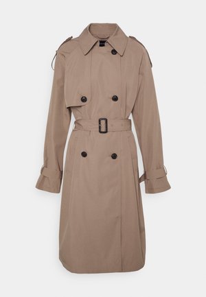 Beige dubbelgeknoopte trenchcoat met zwarte knopen, tailleceintuur, schouderepauletten en manchettestraps.