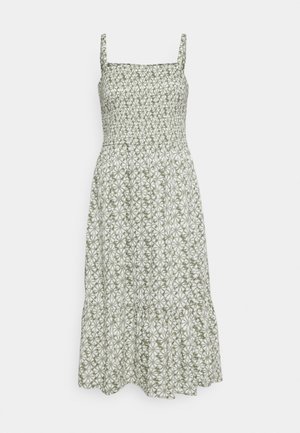 Mouwloze midi-jurk met een vierkante halslijn en een geplooid lijfje, met een groen-wit bloemmotief en een gelaagde rok.