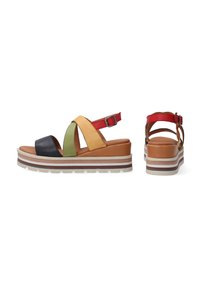 Multicolored wedge sandals with black, green, yellow, and red leather straps, featuring a cushioned footbed and textured sole. Buckle accent on the heel.