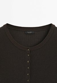 Dark brown ribbed knit cardigan featuring a round neckline and eight button closures down the front. Fabric appears soft and textured.