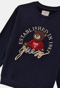 Guess CON RICAMO FRONTALE - Bluză de molton - blu