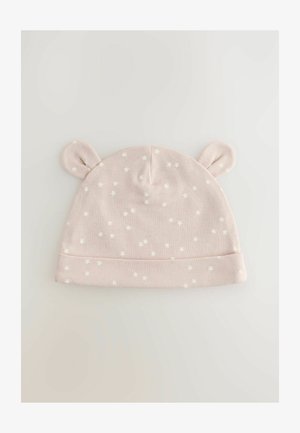 Vaaleanpunainen puuvillainen vauvan hattu, jossa on käännetty reuna, tähtikuvio ja kaksi korvamaisesti ulkonevaa osaa päällä. Pehmeä koostumus, kevyt muotoilu.