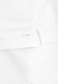 White athletic shirt featuring breathable fabric with a textured pattern and a small "CLIMACOOL" logo on the lower side.