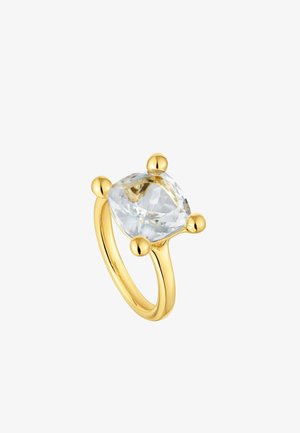 Gold ring featuring a large, faceted clear stone held by four rounded prongs. Smooth, polished band with a curved profile.