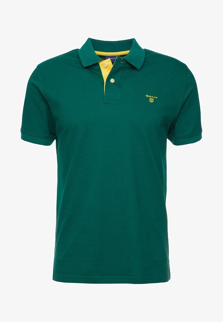 Polo à manches courtes vert foncé avec patte de boutonnage intérieure jaune et petit logo GANT jaune sur la poitrine gauche.