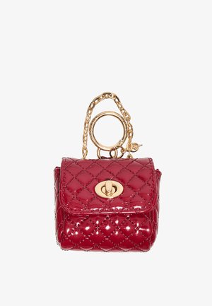 Small shiny red quilted handbag with gold chain strap and oval turn-lock clasp on front flap.
