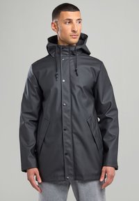 Black waterproof jacket with a hood, snap buttons, and two front pockets. Features a smooth texture and adjustable drawstring.