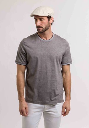 Gray short-sleeve t-shirt with a round neckline and contrasting trim, paired with white pants. Material appears soft and lightweight.
