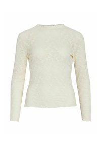 Top in pizzo color crema a maniche lunghe con scollo rotondo e motivo floreale in rilievo. Presenta una silhouette aderente e dettagli con orlo grezzo.