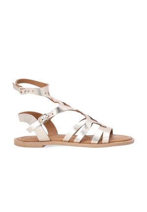 Metallic gold gladiator sandal with ankle straps, open toe, and five horizontal straps across the foot. Smooth leather and flexible sole.