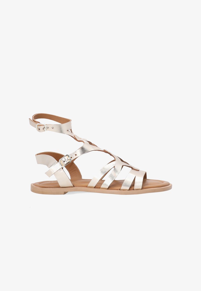 Metallic gold gladiator sandal with ankle straps, open toe, and five horizontal straps across the foot. Smooth leather and flexible sole.