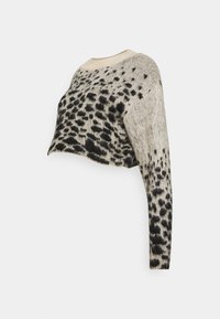 Cropped sweater in beige knit with black spotted pattern. Features a round neckline and long sleeves, showcasing a textured finish.