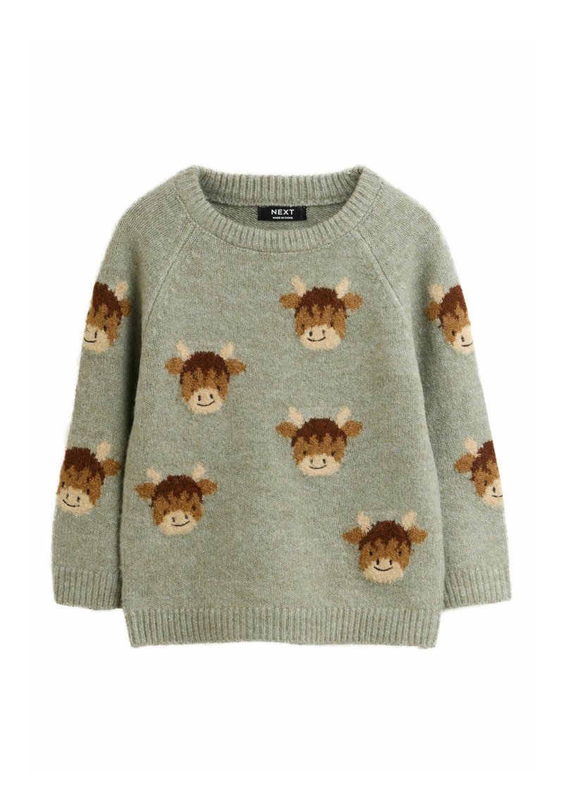 Világoszöld pulóver, amelyen barna és krémszínű tehénfejek ismétlődő mintája található. Puha tapintású, kerek nyakkivágással és bordázott mandzsettákkal rendelkezik.