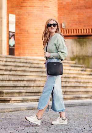 Light green knitted sweater, denim maxi skirt with side slits, black quilted crossbody bag, and beige sneakers with grey accents.