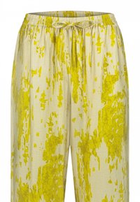 Lichtbeige gemerkte broek met een geel abstract ontwerp, voorzien van een elastische tailleband met een trekkoord voor een verstelbare pasvorm.