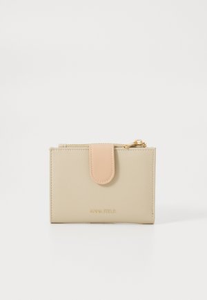 Beige faux leather wallet with a pink snap closure and gold hardware. Features a smooth texture and embossed branding on the front.