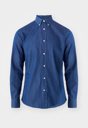Chemise en denim bleu foncé avec un col boutonné, des manches longues et un ourlet droit. Présente des boutons blancs sur le devant.
