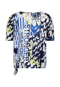 Short-sleeve top in white, blue, and yellow floral pattern with text. Features a loose fit and knotted detail at the hem.