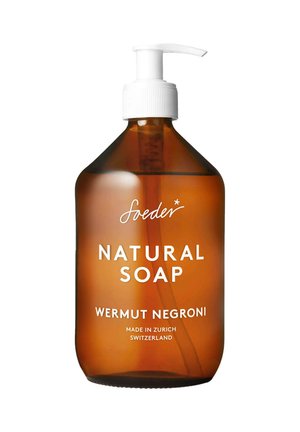 Bottiglia di sapone naturale ambrata con un tappo a pompa bianco. L'etichetta riporta "Sapone Naturale Wermut Negroni" con "Prodotto a Zurigo, Svizzera."