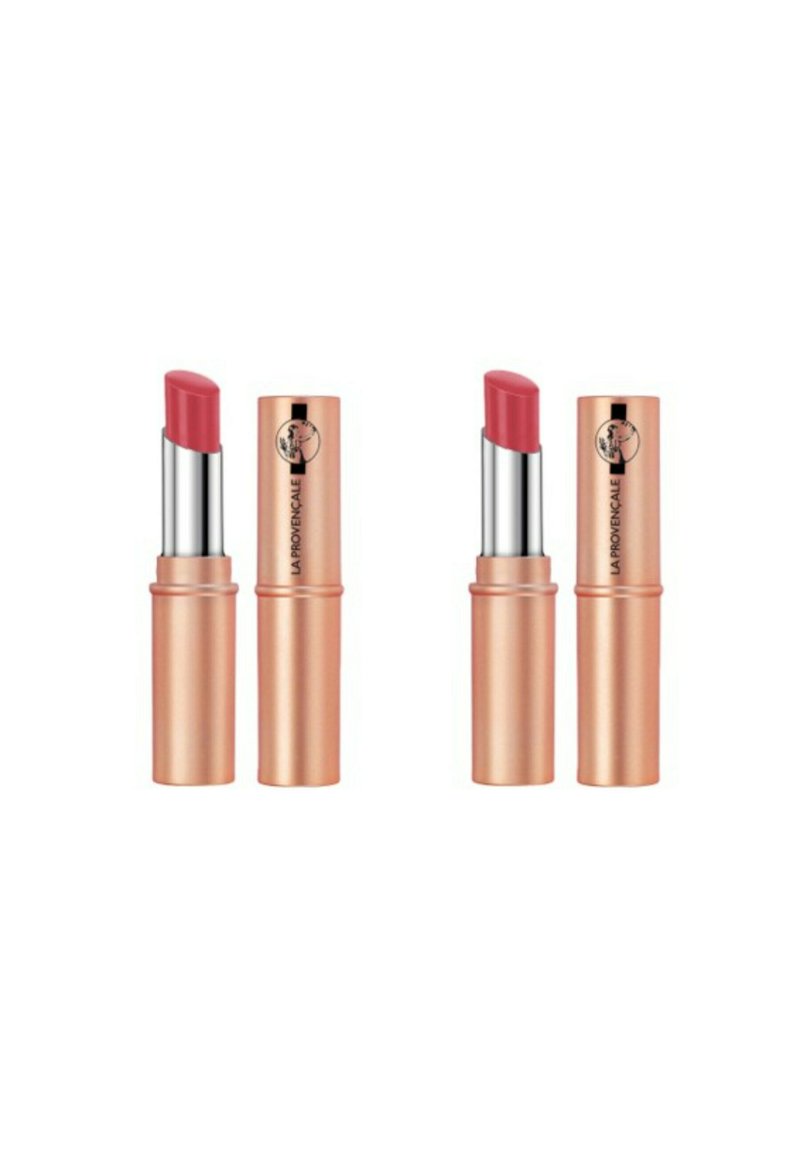 Deux rouges à lèvres dans des étuis cylindriques en or rose avec des accents argentés. Chacun a une pointe lisse et arrondie dans une teinte rose doux.