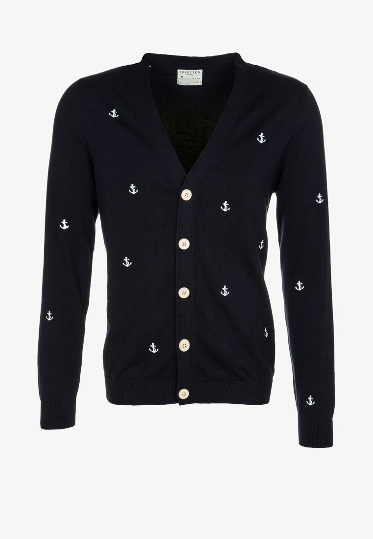 Námořnický kardigan s bílou výšivkou kotvy, výstřihem do V, pěti dřevěnými knoflíky, žebrovanými rukávy a lemem. Měkká pletená látka.