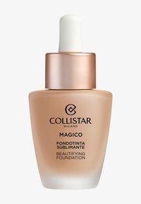 Fond de teint Magico Beautifying de Collistar dans un flacon en verre transparent à base arrondie, liquide beige, pipette blanche et bouchon en or rose.