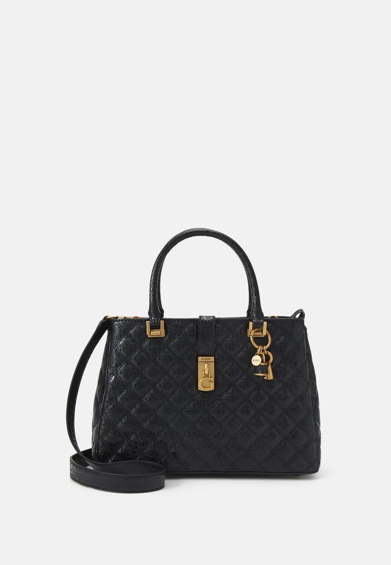 Sac à main noir matelassé avec fermeture dorée, breloque en forme de clé et double anses, doté d'une bandoulière amovible.