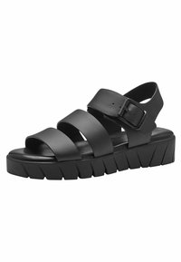 Black platform sandals featuring three wide straps, a side buckle for adjustment, and a thick, textured sole with a zigzag pattern.