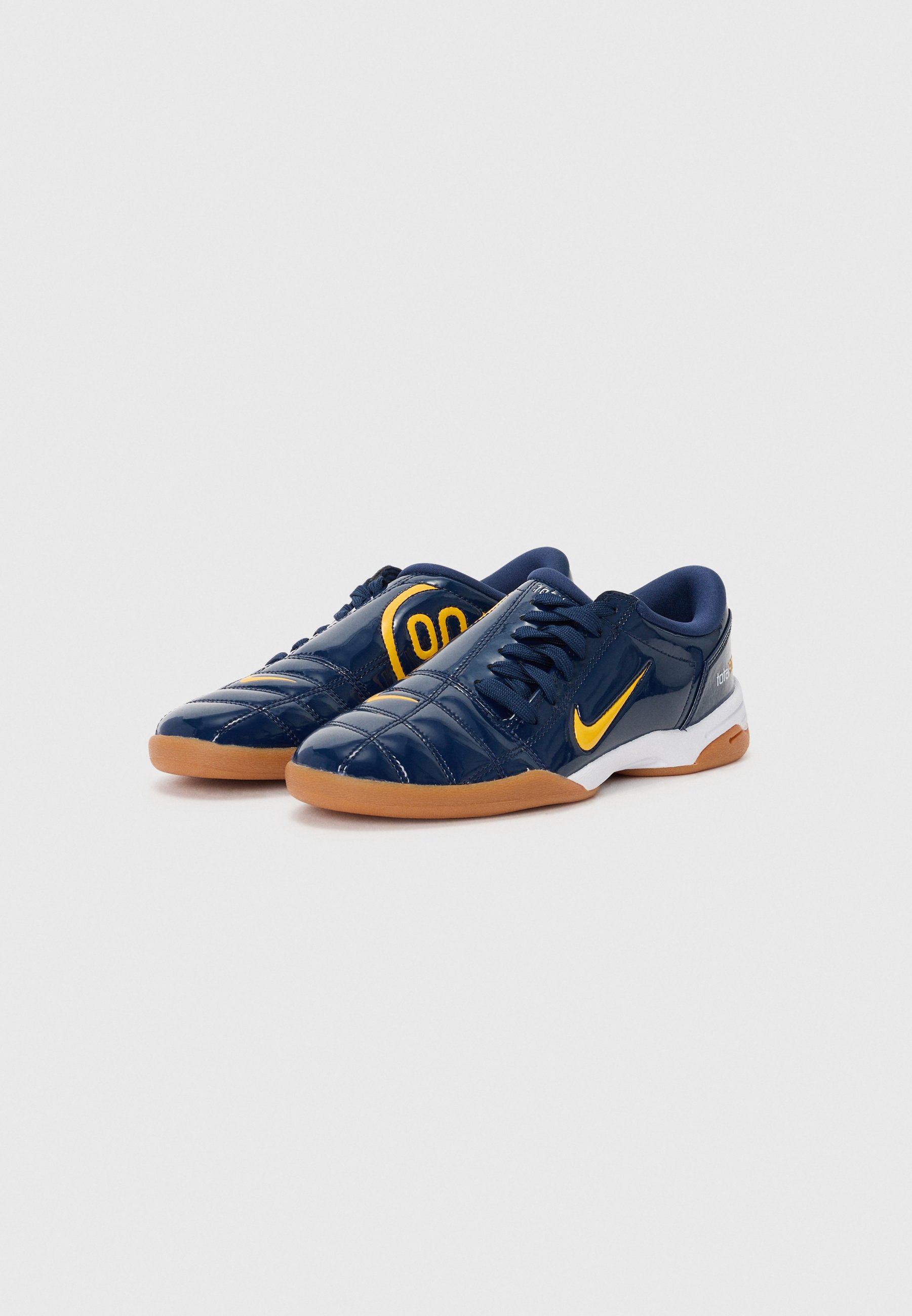 navy and gold nike trainers