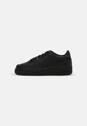 Black leather sneakers with a smooth texture, featuring a rounded toe, flat laces, and a rubber sole. Nike logo embossed on the side.
