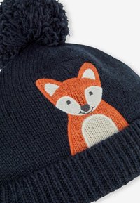 Knitted navy beanie with a soft pom-pom top; features an embroidered orange fox design on the front with white and black accents.