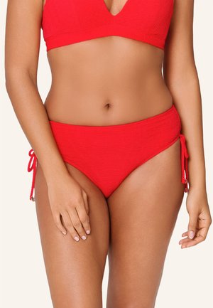 Top bikini rosso con texture, profondo scollo a V e fondo abbinato a vita alta con lacci laterali e dettagli in metallo argentato.