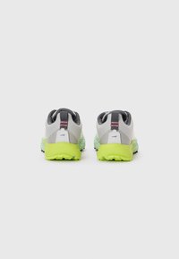 Pair of light gray athletic shoes with bright green soles, black heel loops with pink stitching, shown from the back on a white background.