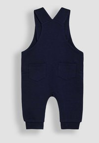 Salopette pour enfants bleu marine en coton, dotée de bretelles réglables, d'un col rond et de deux poches arrière avec des poignets élastiques.