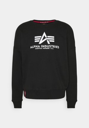 Sort langærmet sweatshirt med hvidt Alpha Industries-logo og teksten "Knoxville, Tennessee, U.S.A.", centreret på brystet.