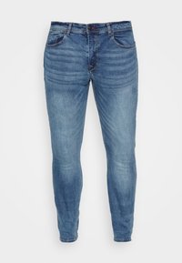 Jeans din denim albastru, cu o croială slim, cinci buzunare și închidere cu nasture. Materialul are un finisaj decolorat, cu detalii ușor uzate.