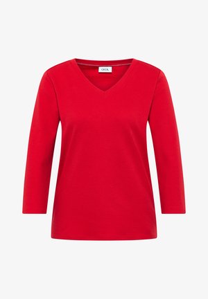 Červené tričko s dlouhým rukávem a výstřihem do V, vyrobené z měkkého bavlněného materiálu. Má uvolněný střih a jednoduché švy podél výstřihu.