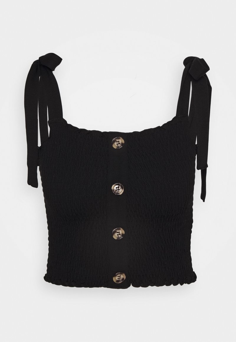 Top corto negro con textura smock, con tirantes ajustables, un cierre frontal con botones metálicos grandes y un dobladillo con forma de onda.