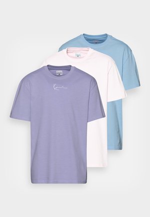 Three short-sleeve T-shirts in lavender, pink, and light blue, featuring a crew neckline and a small white logo on the front.