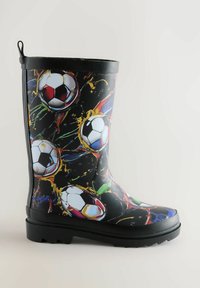 Black rubber rain boot with a soccer ball print and colorful splashes. Features a textured sole and pull tab for easy wearing.