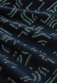 Navy fabric with white and teal abstract line patterns, creating a textured appearance. Material appears soft and drapes smoothly.