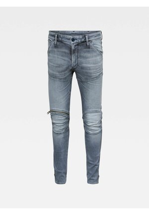 Szare dżinsy slim-fit z panelem na kolanach oraz poziomym suwakiem na lewej udzie.