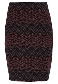 Jupe ajustée en tissu extensible avec une base noire présentant des motifs en zigzag rouge et bleu. L'ourlet est droit sans qu'aucune quincaillerie ne soit visible.
