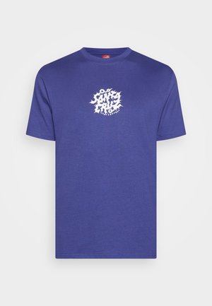T-shirt violet à manches courtes avec un texte graphique blanc "Santa Cruz Skateboards" et des formes ressemblant à des engrenages au centre devant.