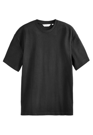 T-shirt nera in cotone con maniche corte, collo a giro, vestibilità ampia e texture liscia. Nessun motivo o accentuazione visibile.