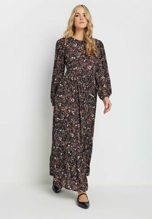 Vestido maxi negro con estampado floral, mangas largas, cintura fruncida y pequeños patrones de flores multicolores. Tejido suave con una silueta fluida.