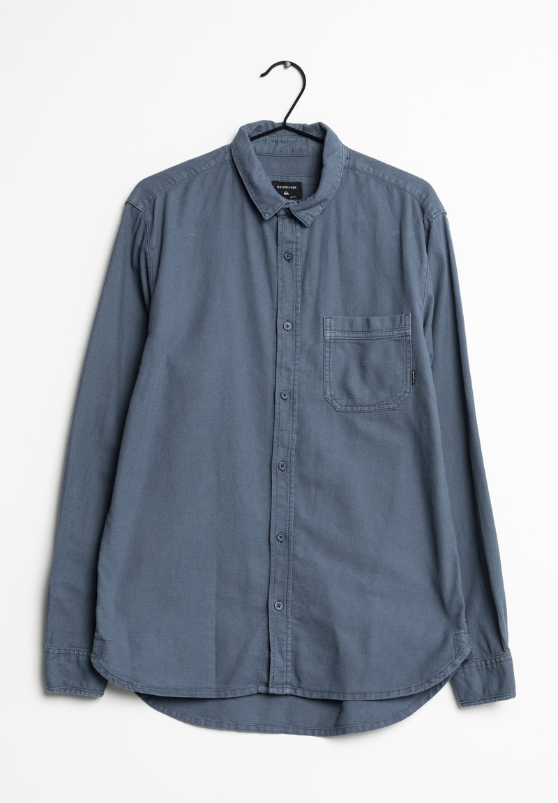 Košile s dlouhým rukávem v tmavě modré barvě ze 100% bavlny. Obsahuje límec na knoflíky, náprsní kapsu a zakřivený spodní lem.
