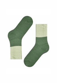 Zielone skarpetki prążkowane z jednolitą, jasnolimonkową gumką na górze. Miękka tekstura z gładkim wykończeniem, zaprojektowane dla komfortu i dopasowania.