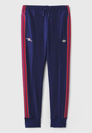 Navy blue athletic joggers with red and white side stripes, embroidered logo details, drawstring waist, and elastic cuffs at the ankles.
